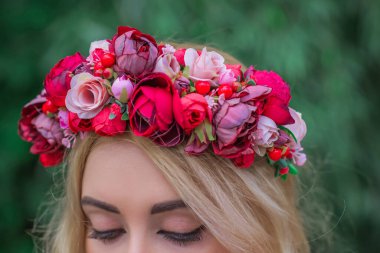 Kafasında çiçek çelengi olan bir kadın. Romantik çelenk giymiş güzel bir kız.  