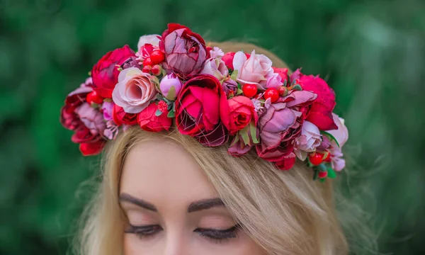 Woman With Flower Wreath On Her Head. Beautiful girl in romantic wreath