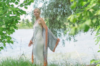 Doğada boho tarzı kıyafetler giyen etnik hippi bir kadın. Açık hava modası. Boho tarzı ve etno kavramı