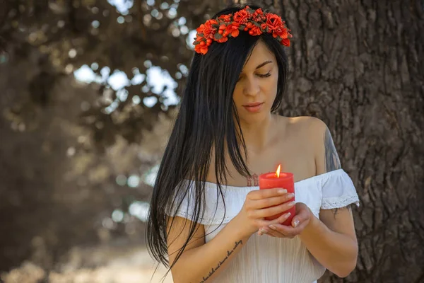 Woman with Candle at nature. Magical attribute, witchcraft concept, fire, Spells and other rite