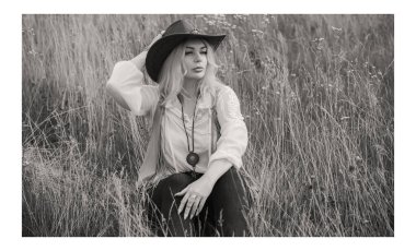 Woman Plus size in American country style black boho jacket, with a fringe, shirt and cowboy hat at nature