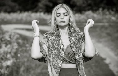 Ethnic gypsy woman posing in boho style clothes at nature. Outdoor fashion. Concept of ethnos style 