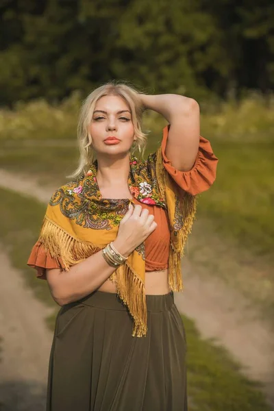 Ethnic gypsy woman posing in boho style clothes at nature. Outdoor fashion. Concept of ethnos style