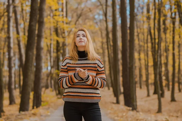 Autumn time, woman in warm clothes, new collection, black- orange sweater and dark outfit