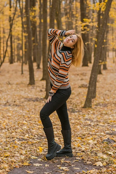 Autumn time, woman in warm clothes, new collection, black- orange sweater and dark outfit