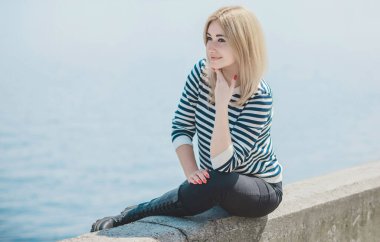 Girl in striped sweeter, fashionable details on a model, classical trend in wardrobe