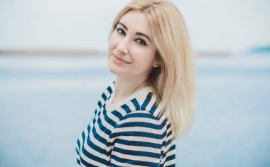 Girl in striped sweeter, fashionable details on a model, classical trend in wardrobe