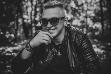 Smiling young handsome stylish student, blonde guy, lifestyle of teen- youth life. Portrait of young man