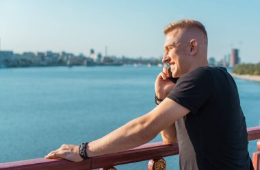 Smiling young handsome stylish student, blonde guy, lifestyle of teen- youth life. Portrait of young man