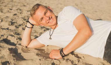 Smiling young handsome stylish student, blonde guy, lifestyle of teen- youth life. Portrait of young man