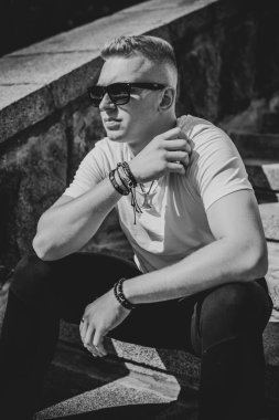 Young stylish Nordic blonde guy, portrait of modern youth. Confident boy with stylish clothes and accessories