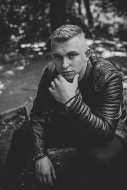 Young stylish Nordic blonde guy, portrait of modern youth. Confident boy with stylish clothes and accessories