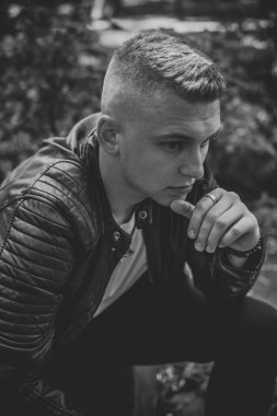 Young stylish Nordic blonde guy, portrait of modern youth. Confident boy with stylish clothes and accessories
