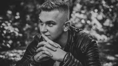 Young stylish Nordic blonde guy, portrait of modern youth. Confident boy with stylish clothes and accessories