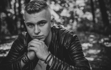 Young stylish Nordic blonde guy, portrait of modern youth. Confident boy with stylish clothes and accessories