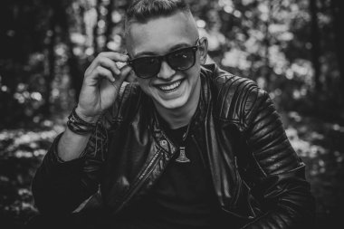 Young stylish Nordic blonde guy, portrait of modern youth. Confident boy with stylish clothes and accessories