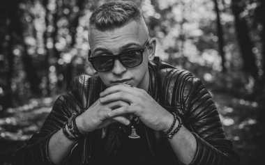 Young stylish Nordic blonde guy, portrait of modern youth. Confident boy with stylish clothes and accessories