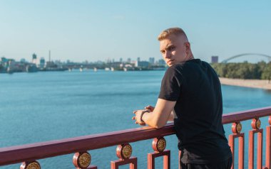 Young stylish Nordic blonde guy, portrait of modern youth. Confident boy with stylish clothes and accessories