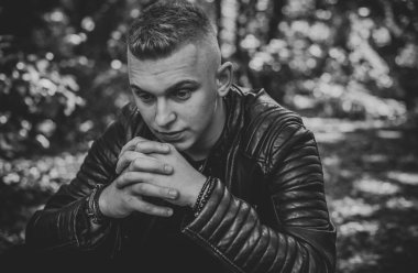  Young European man with a sad philosophical mood. The concept of life, problems and depression. Crisis of young age