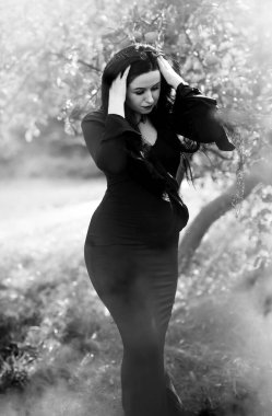 Halloween time, witch Lady in Mystical atmosphere, witchcraft concept, ideas for mysterious Party. Addams family 