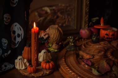 Halloween composition pumpkin orange candles, mystical design for home, interesting ideas for party, details of dcor