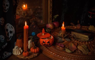 Halloween composition pumpkin orange candles, mystical design for home, interesting ideas for party, details of dcor