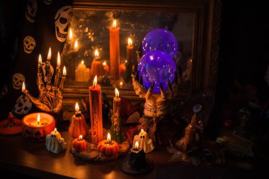 Halloween composition pumpkin orange candles, mystical design for home, interesting ideas for party, details of dcor