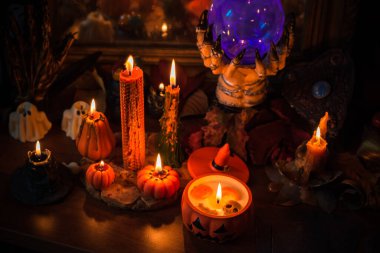 Halloween composition pumpkin orange candles, mystical design for home, interesting ideas for party, details of dcor