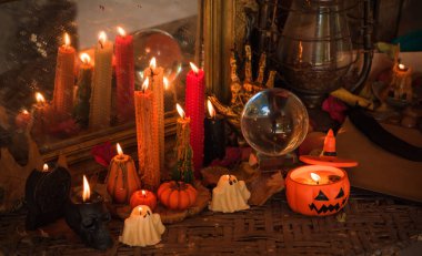 Halloween composition pumpkin orange candles, mystical design for home, interesting ideas for party, details of dcor