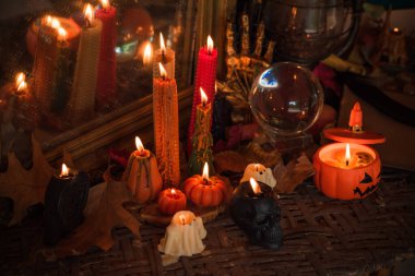 Halloween composition pumpkin orange candles, mystical design for home, interesting ideas for party, details of dcor