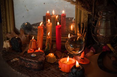 Halloween composition pumpkin orange candles, mystical design for home, interesting ideas for party, details of dcor