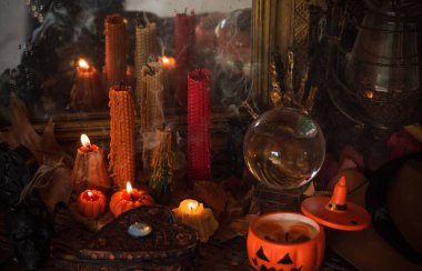 Halloween composition pumpkin orange candles, mystical design for home, interesting ideas for party, details of dcor