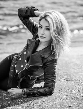 A young woman in leather jacket. Concept of grunge style 90x, mix clothes, outfits for women