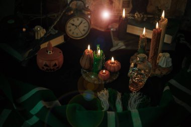 Sihirli şeylerin tasviri... mum ışığı, sihirli değnek, büyü kitabı karanlık arka plan, büyücülük okulu, yeşil estetik, Cadılar Bayramı zamanı