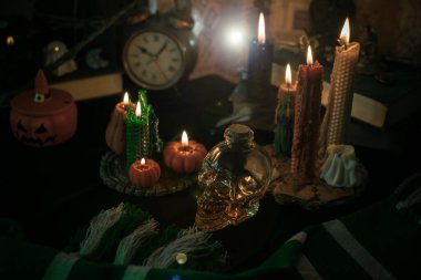 Sihirli şeylerin tasviri... mum ışığı, sihirli değnek, büyü kitabı karanlık arka plan, büyücülük okulu, yeşil estetik, Cadılar Bayramı zamanı