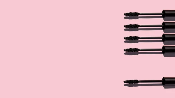 Creative layout of mascara brush on pink background. Make up products. Make up artist, beauty or cosmetic studio concept. Copy space. Cosmetic products. Top view. Place for text and design. Banner.