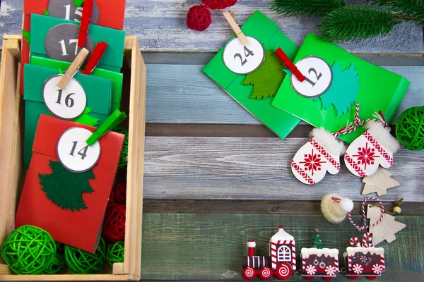 Masada, ahşap bir kutuda Noel takvimi var. El yapımı çok renkli zarflar.