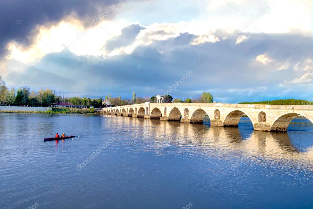 Those who canoe in the Meric river in Edirne. Canoeists passing under the Mecidiye Bridge. Blue sky and peaceful times.
