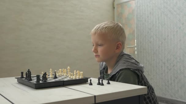 Cute little boy gra w szachy w domu. — Wideo stockowe