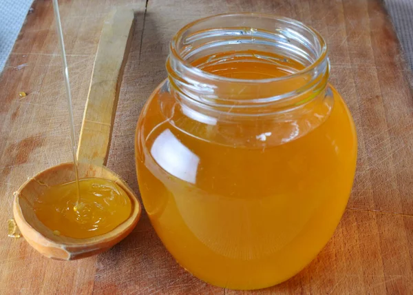 Fresh Natural Organic Honey Being Poured Wooden Spoon Next Jar — Stockfoto