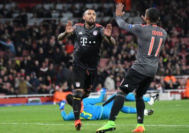 LONDON, ENGLAND - 7 Mart 2017: Bayern 'li Arturo Vidal, Emirates Stadyumu' ndaki Arsenal FC ve Bayern Munchen arasında oynanan 16 maçlık UEFA Şampiyonlar Ligi ikinci turunda attığı golün ardından Douglas Costa (R) tarafından kutlandı. Telif Hakkı