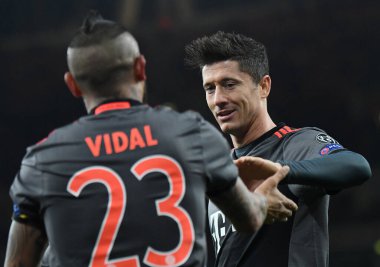 LONDON, ENGLAND - MARCH 7, 2017: Arturo Vidal of Bayern celebrates with Robert Lewandowski (R) after he scored a goal during the second leg of the UEFA Champions League Round of 16 game between Arsenal FC and Bayern Munchen at Emirates Stadium.v