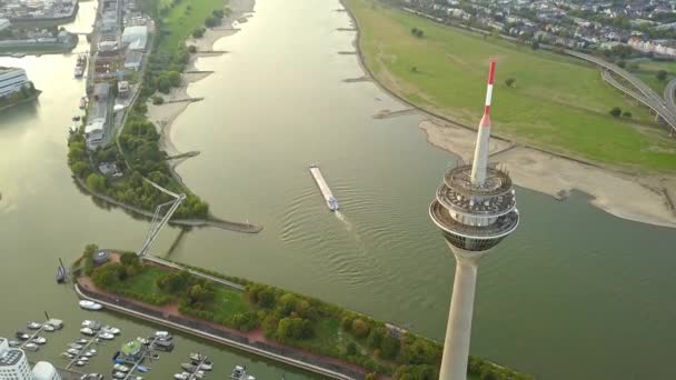 Sunrise By The Rhine River In Dusseldorf, Germany. Aerial View Of The Iconic Rheinturm Overlooking Skyline Buildings By The Riverbank - tilt-up drone — Stock Video