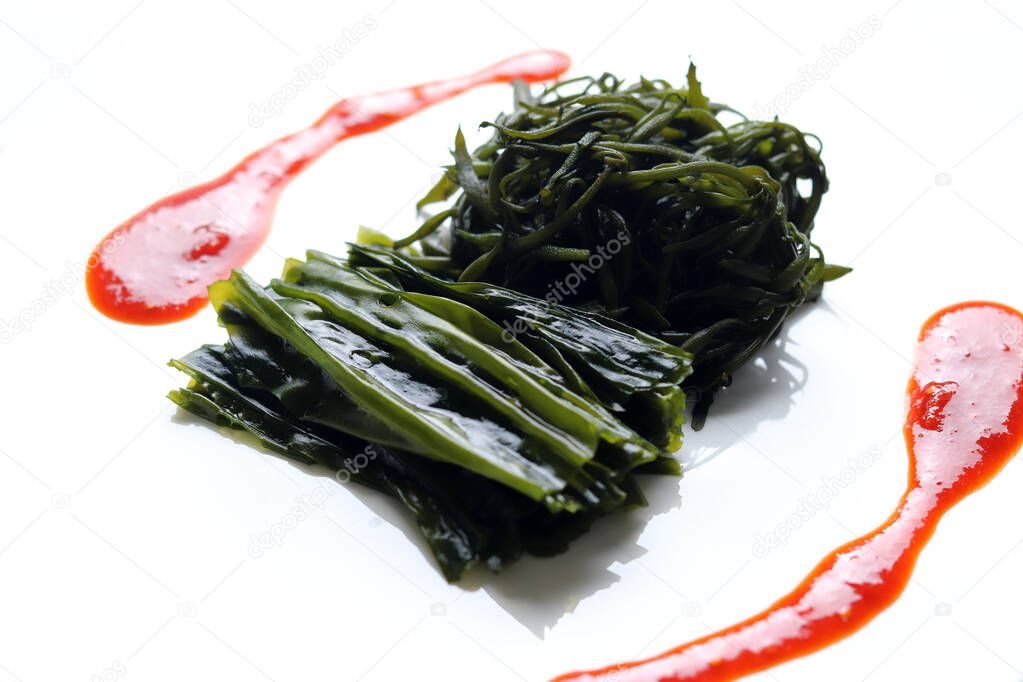 Seaweed and Seaweed fusiforme blanched in boiling water and red chili-pepper paste with vinegar. Red chili-pepper paste with vinegar and seaweed dishes.