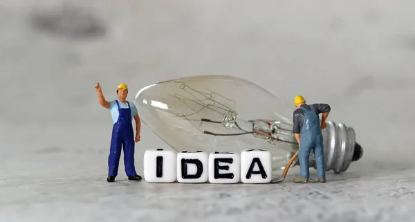Żarówka Miniaturowi Ludzie Koncepcją Biznesu Biały Sześcian Słowem Idea — Zdjęcie stockowe