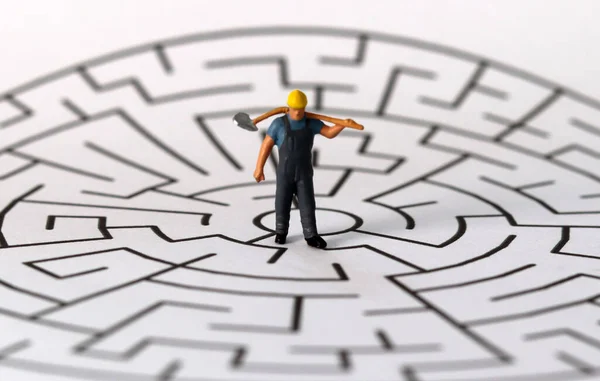 A miniature man on the puzzle. Business concept with miniature and puzzle. Business concept with miniature and puzzle.