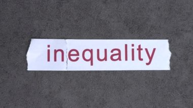 The IN text on paper blew away in the wind. The concept of inequality and equality.