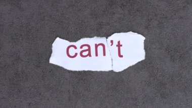 The T text on paper blew away in the wind. The concept of can and can't.