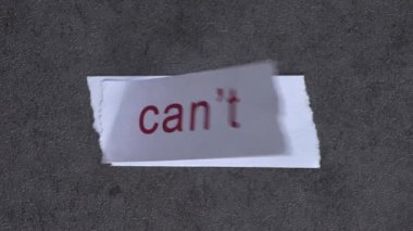 Replace the word CAN'T with the word CAN. Business concept with letters and wobbly paper.