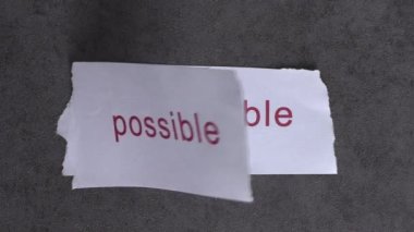 Replace the word impossible with the word possible. Business concept with letters and wobbly paper.